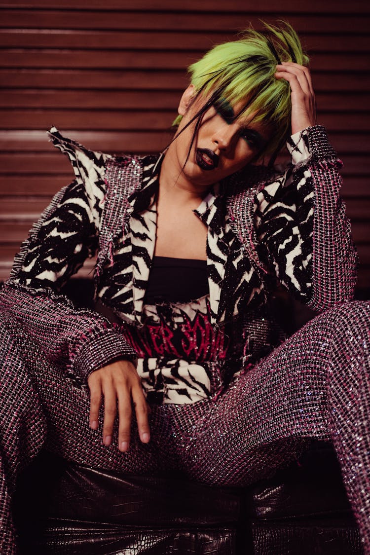 Extravagant Ethnic Woman In Wig Resting On Couch