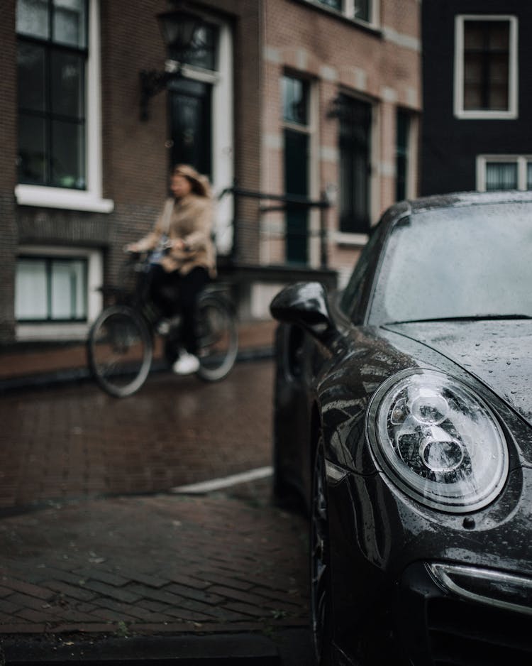 Black Car Parked On The Sidewalk Of The Street