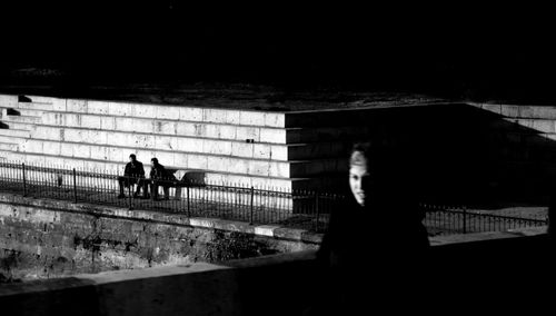 Free A dark, moody cityscape in Eskişehir, Turkey with silhouetted figures. Stock Photo