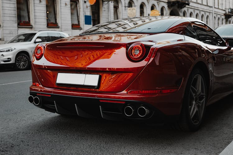 Red Ferrari Parked On Roadside