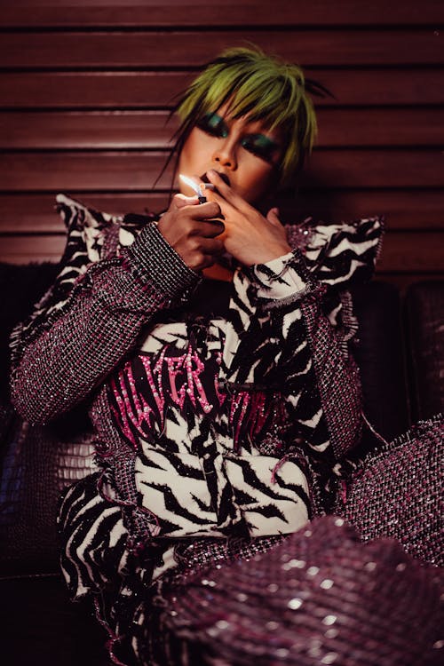 Stylish model with bright hairstyle smoking cigarette