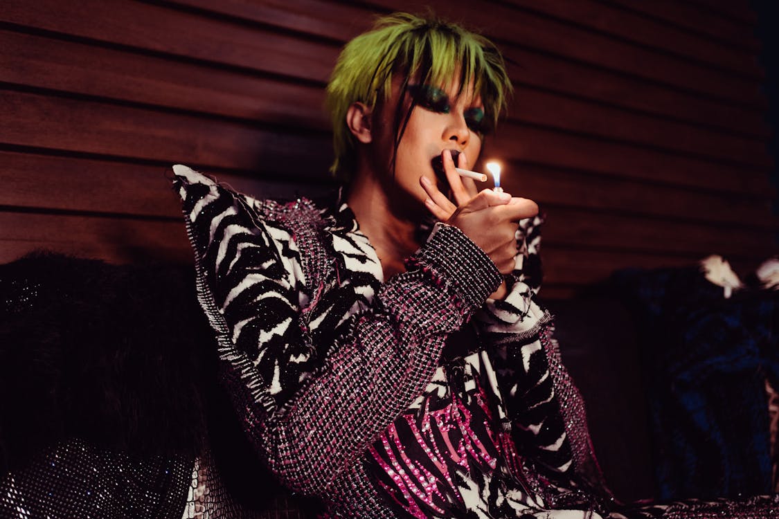 Thoughtful transgender model in stylish outfit smoking cigarette · Free ...