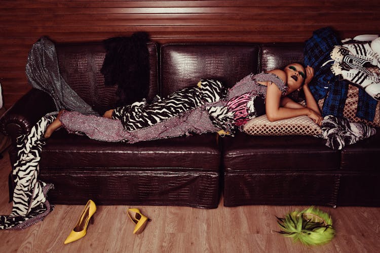 Stylish Woman In Bright Outfit On Couch