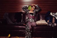 Stylish transgender sitting on couch