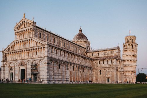 Free Capture of the Leaning Tower and Pisa Cathedral at sunset in Italy. Stock Photo
