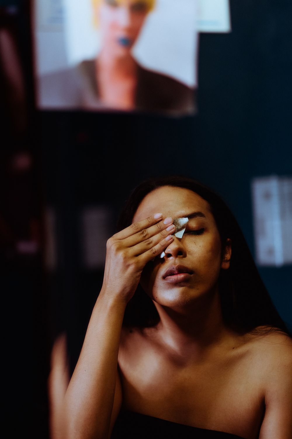 Male crossdresser in mirror tissuing face · Free Stock Photo