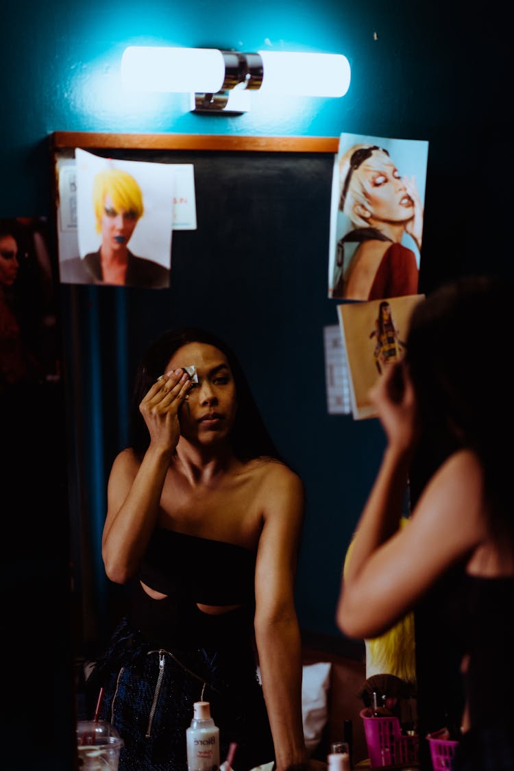 Ethnic Woman Removing Makeup In Dressing Room