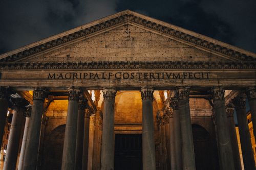 Free Capturing the impressive illuminated front of the Pantheon in Rome during a serene night. Stock Photo