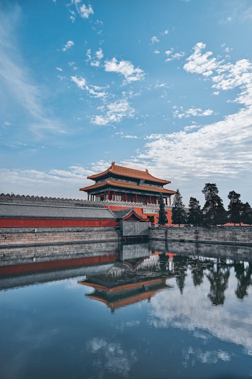Free Brown and Black Temple Near Body of Water Under Blue Sky Stock Photo
