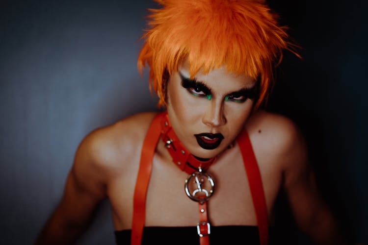 Eccentric Woman With Dark Makeup And Dyed Orange Hair