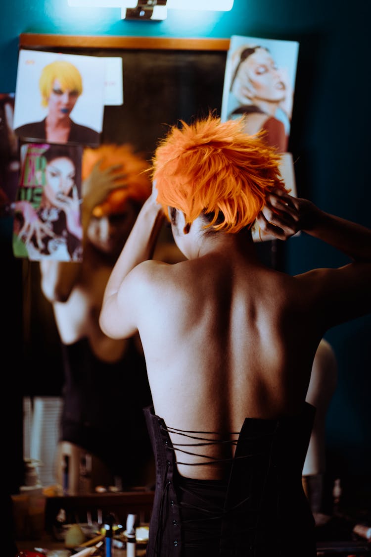 Informal Woman Putting On Orange Wig