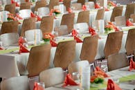 Long Tables With White Cloths and Brown Chairs Formal Setting