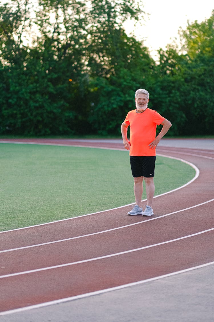 Senior Man In Sportswear On Stadium Track