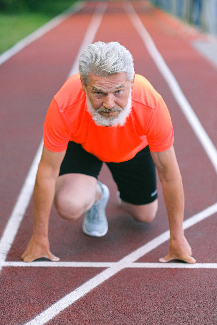 Serious Elderly Man Preparing For Jogging