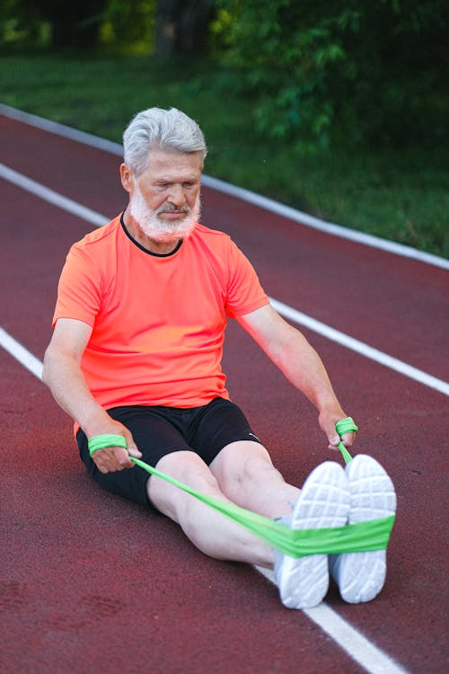 Fit elderly man stretching with resistance band