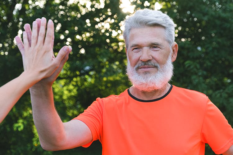 Senior Man Giving Five To Friend