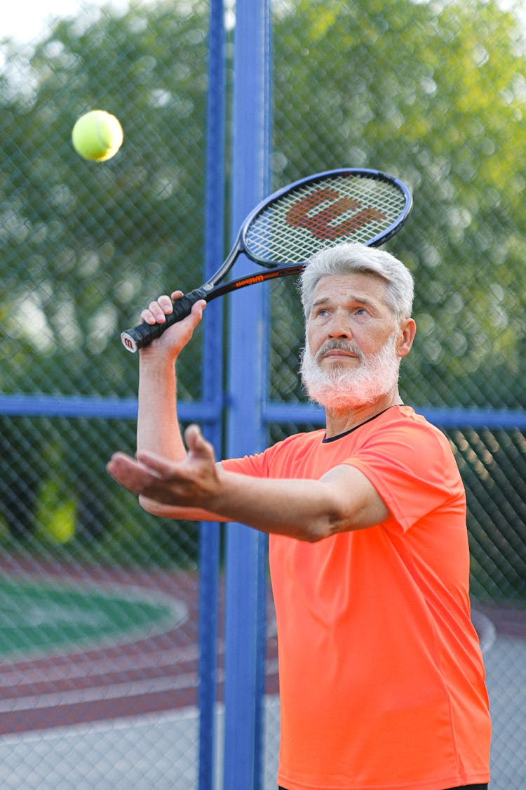 Focused Tennis Player Hitting Ball