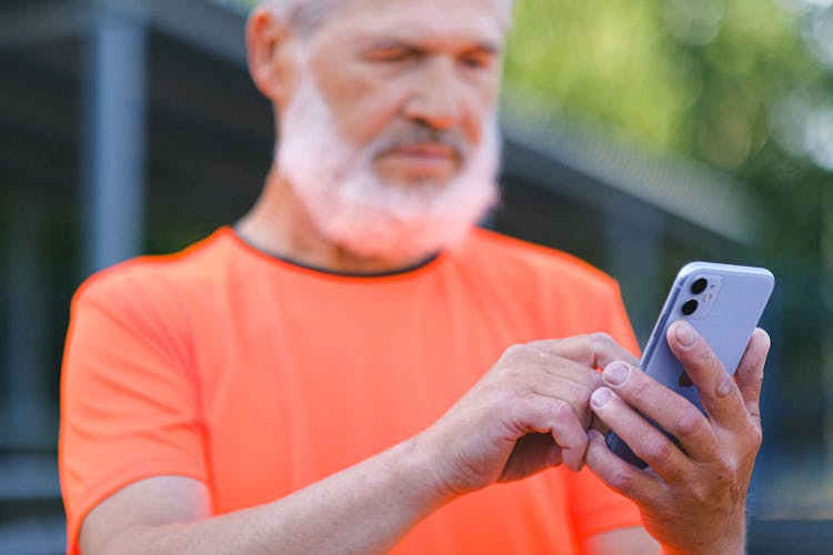 Crop Senior Man Using Smartphone