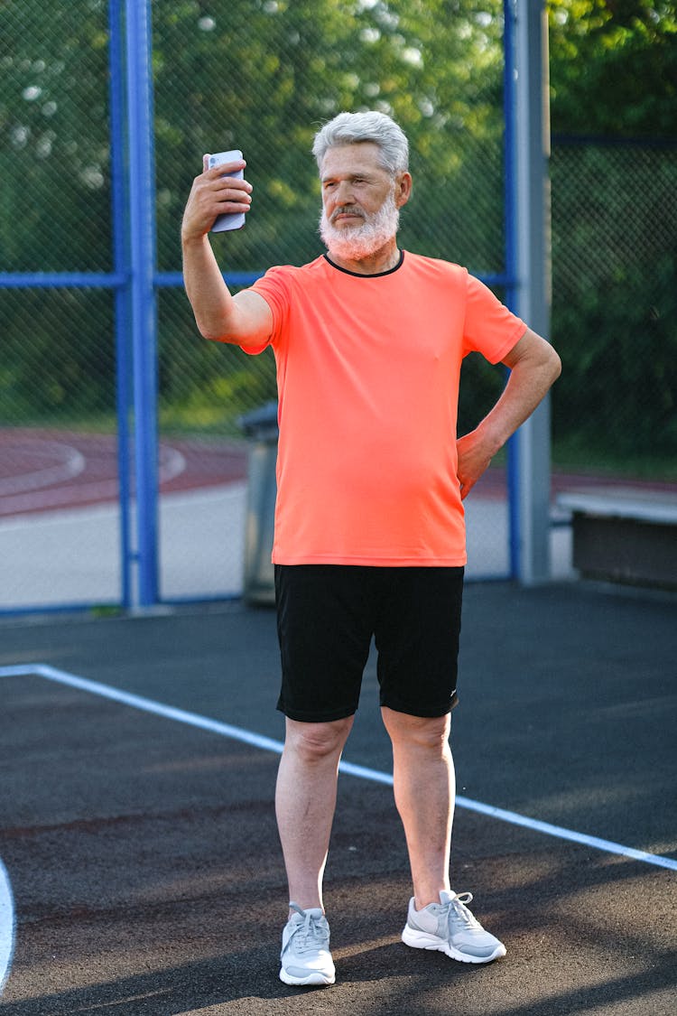 Senior Sportsman Taking Selfie During Training