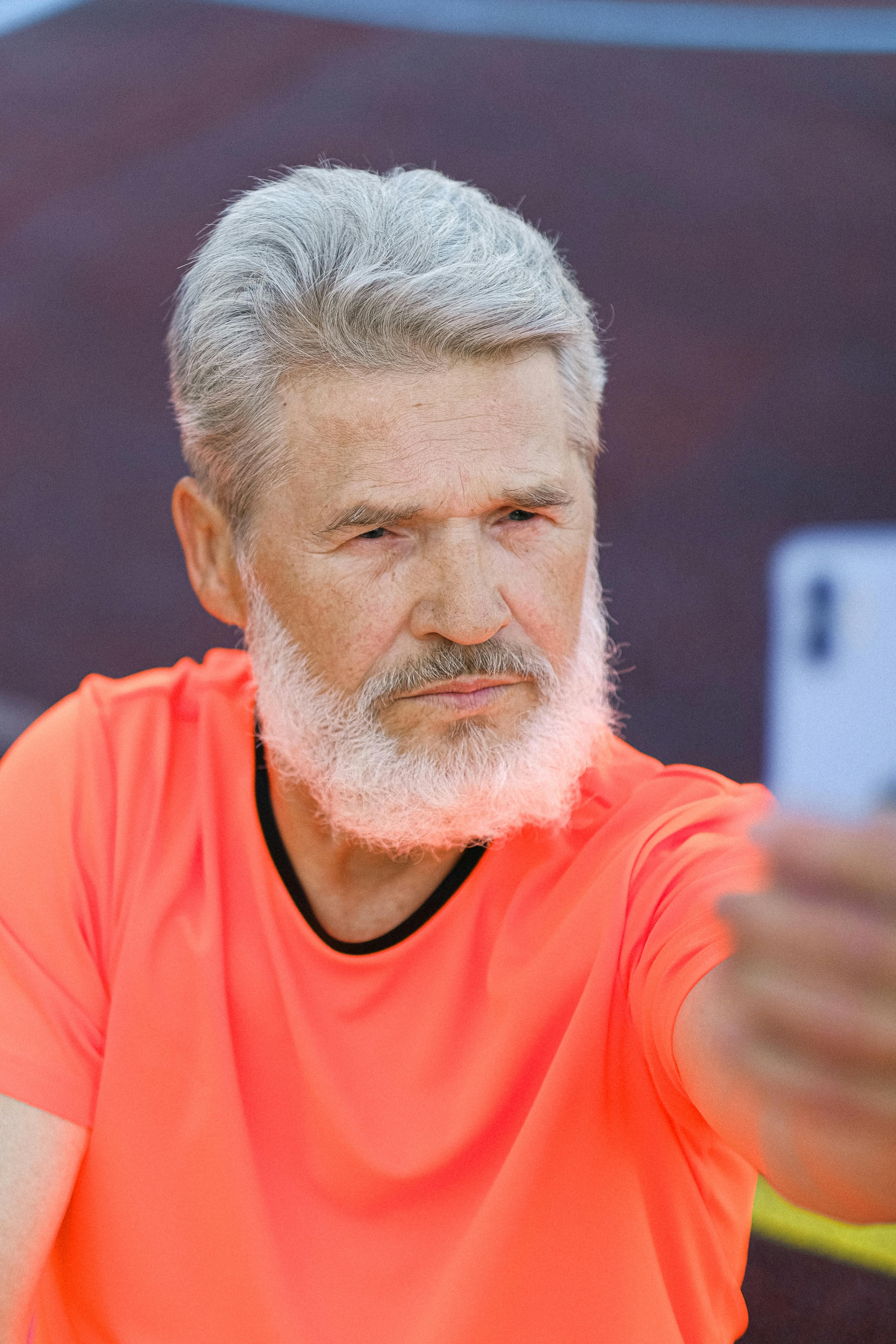 serious mature man taking selfie on stadium