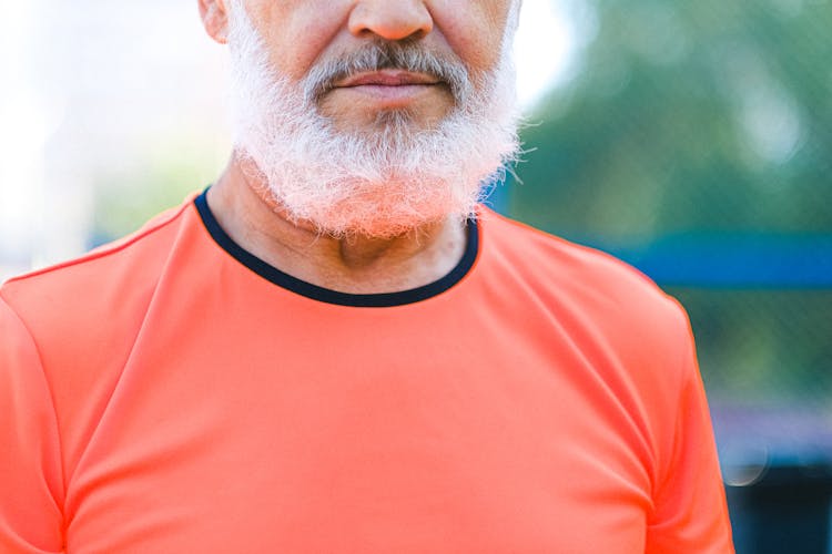 Crop Mature Man Standing In Park