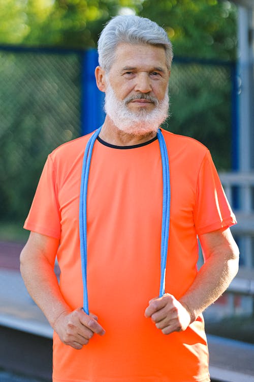 Mature man with fitness rubber on stadium