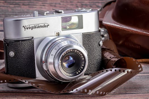 Close-up of a vintage Voigtländer film camera with an unwound film reel, evoking classic photography.