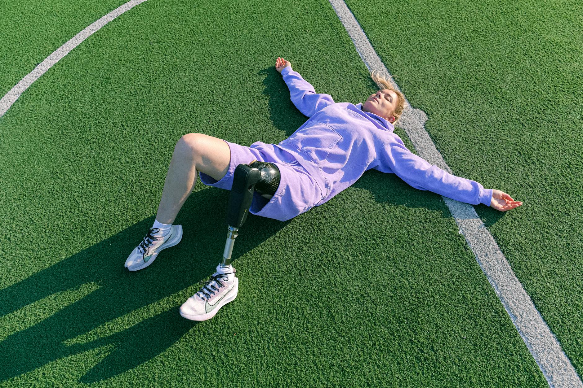 Woman With Prosthetic Leg Lying Down on the Lawn