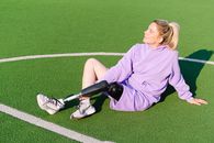 Woman with leg prosthesis on sports court