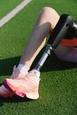 Person in Pink Nike Sneakers Sitting on Black and Gray Golf Club