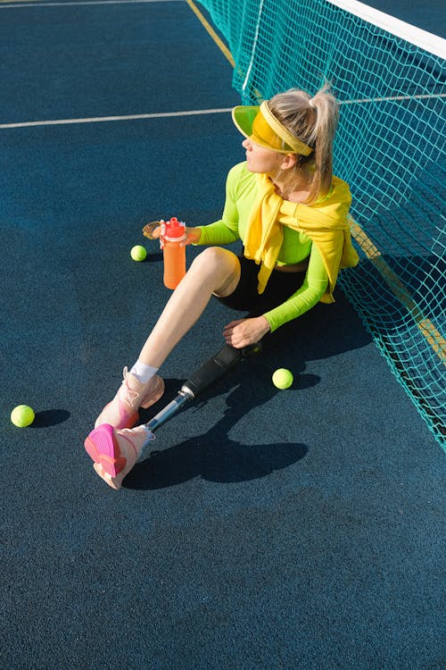 Woman with Prosthetic Leg on Tennis Court