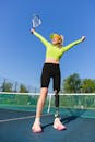 Woman in Yellow Long Sleeve Shirt and Black Leggings Doing Yoga