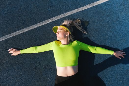 Relaxed woman lying with outstretched arms