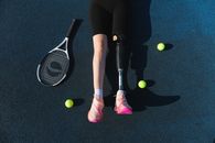 Person in Black Leggings and Pink Shoes Holding White and Black Electric Fly Swatter