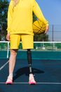 Woman in Yellow Long Sleeve Shirt and Yellow Skirt Holding Black and White Basketball
