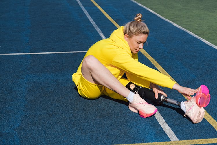 Woman Sitting On Tennis Court