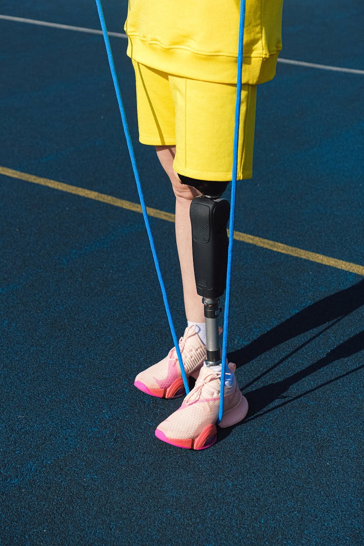 Person With Prosthetic Leg Stepping On A Rope