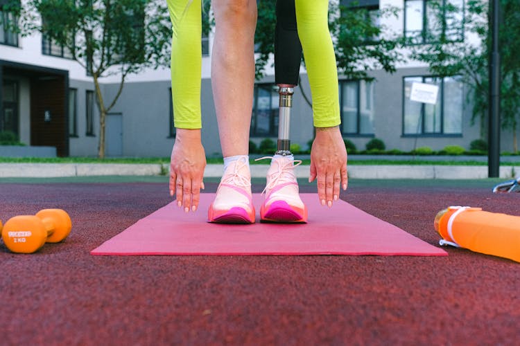 Person With Prosthetic Leg Reaching Her Toes