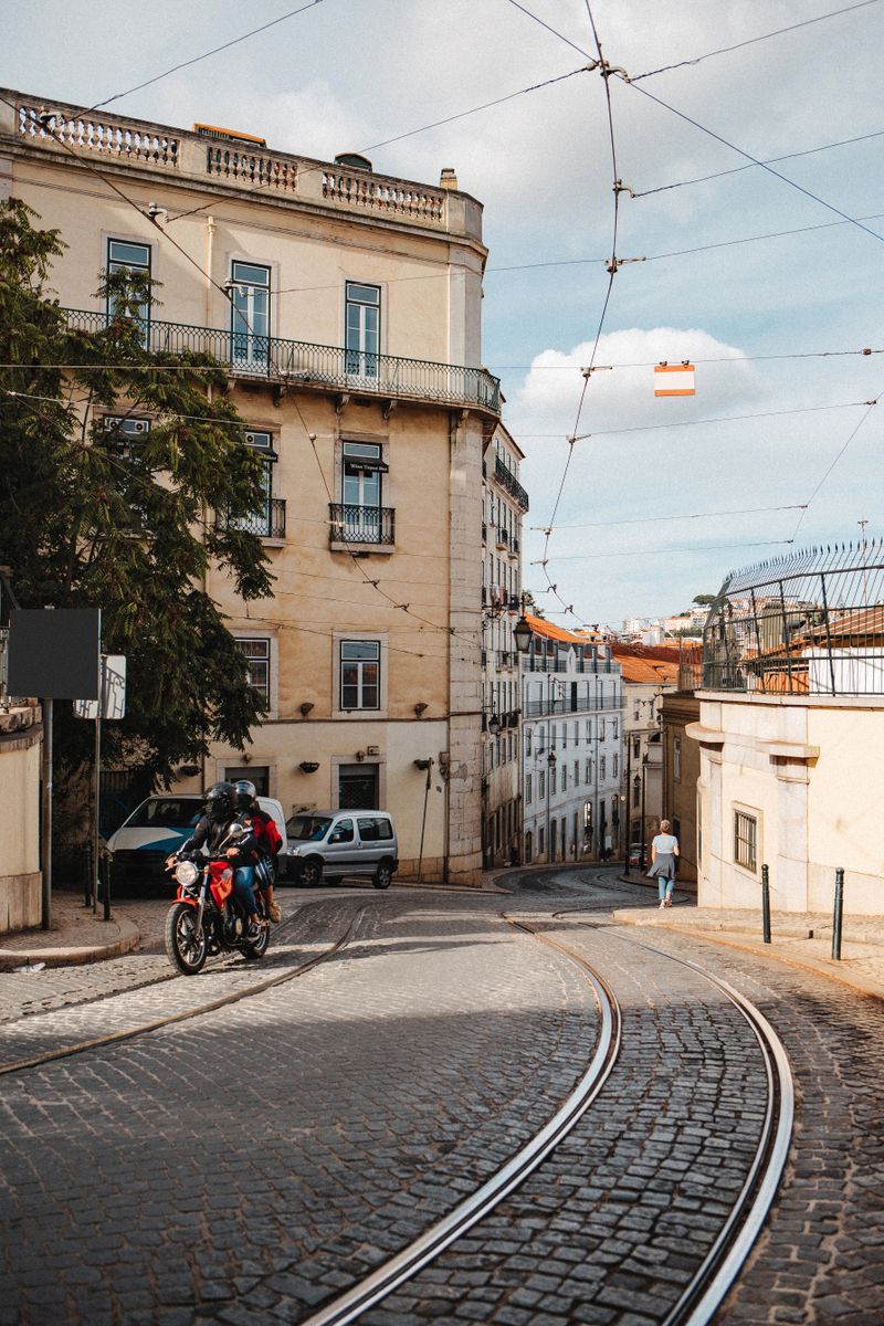 Cobblestone street with tram tracks in Lisbon — photo by Max Avans on Pexels