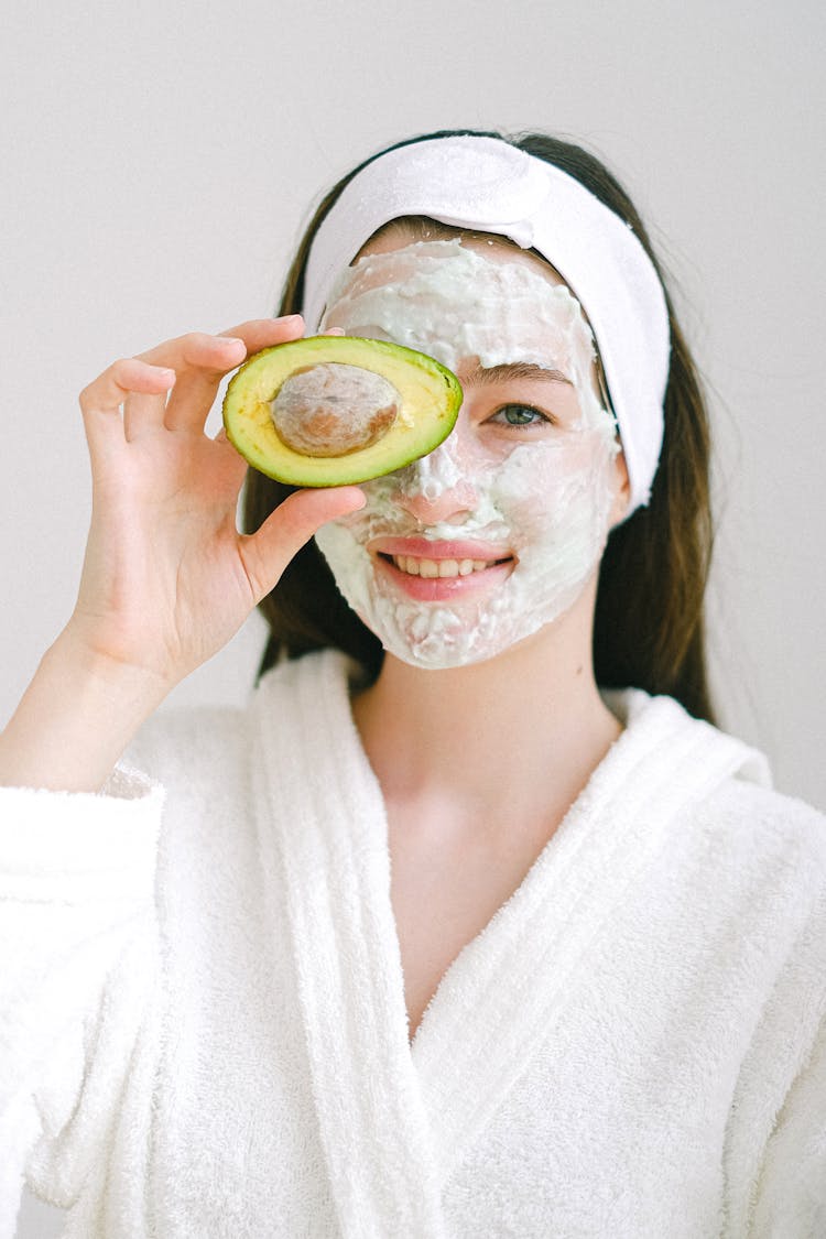 Cheerful Woman With Mask And Avocado
