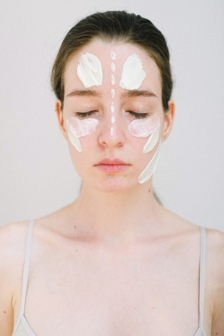 Gentle Young Woman With White Facial Cream Smears