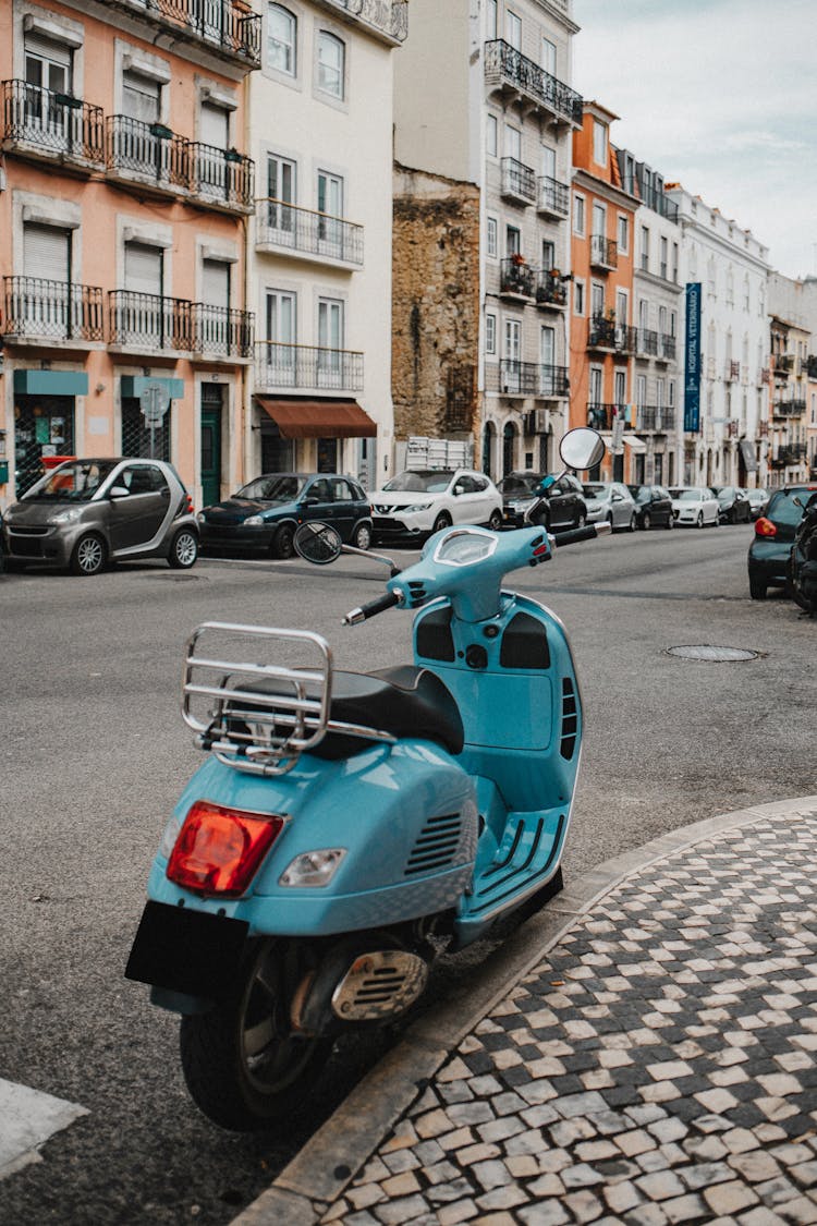 A Blue Scooter Parked On The Street