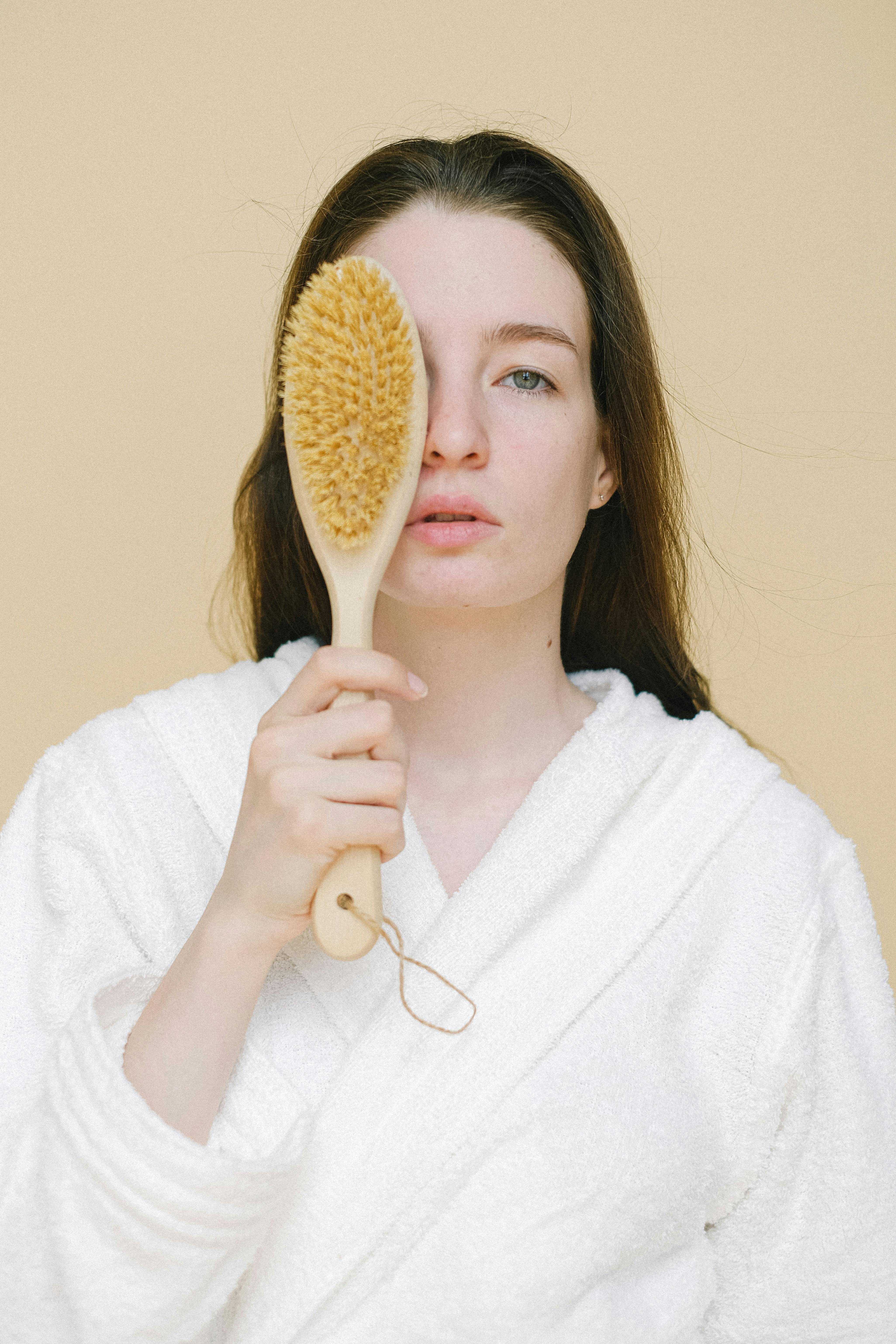 calm woman with brush for dry massage