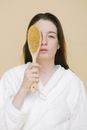 Calm woman with brush for dry massage