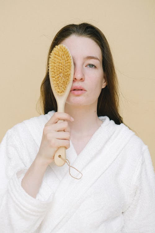 Woman in White Sweater Holding Brown Wooden Spoon