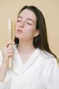 Female brushing face with brush for dry massage