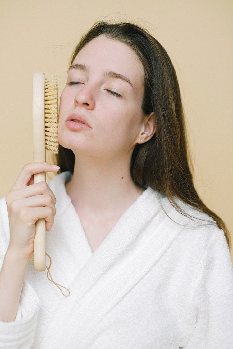 Female Brushing Face With Brush For Dry Massage