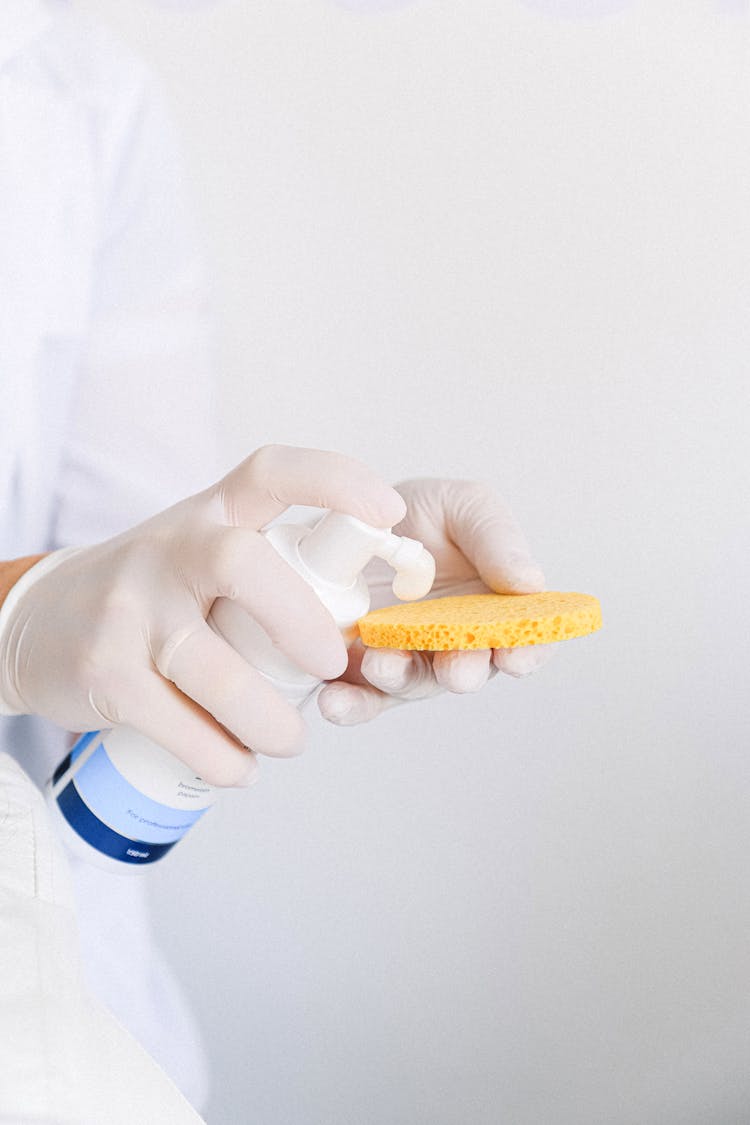 Cosmetologist Pushing Cleansing Foam On Sponge