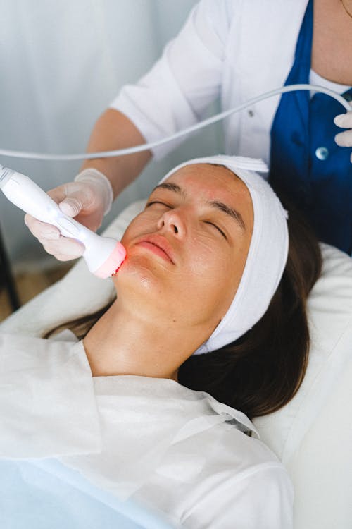 Free Doctor doing anti aging procedure for patient Stock Photo