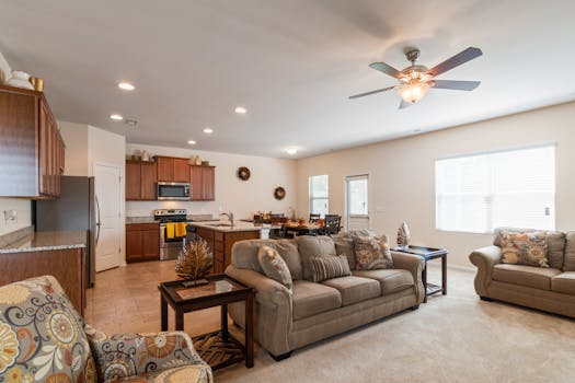 Spacious open-concept living room and kitchen with elegant decor and natural light.